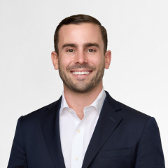 non-profit headshot photography on white background with a male in black suit