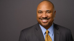 partner headshot on grey background in professional photo studio