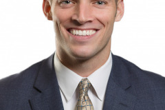 male corporate headshot in blue suit on white background witha  gold tie for style. Arielle Lewis Studios is a high end photo studio in washington DC serving Marlyand as well