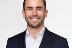non-profit headshot photography on white background with a male in black suit