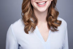 modern headshot on grey background with white dress shirt in studio