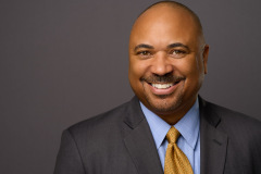 partner headshot on grey background in professional photo studio