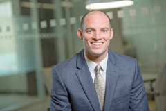 relaxed male enviornmental headshot with natural light in a corporate office in washington DC