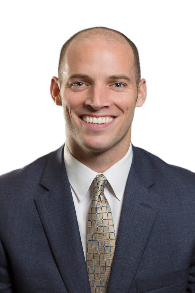 male corporate headshot in blue suit on white background witha  gold tie for style. Arielle Lewis Studios is a high end photo studio in washington DC serving Marlyand as well